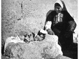 A baby laid in a rock manger. Primitive houses were still found in Bethlehem in the last century.